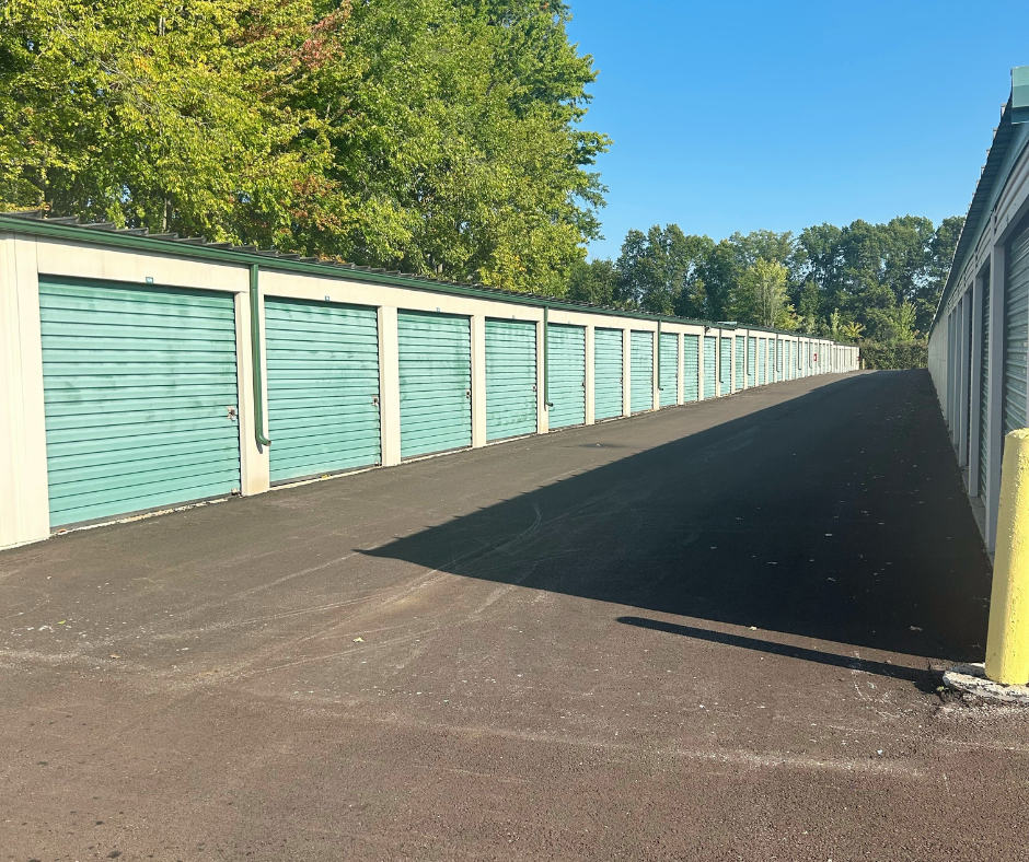 green and tan exterior storage units with black driveway